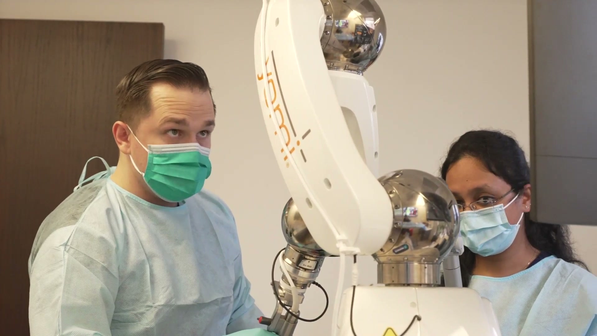 Dr. Barriere and his assistant with the Yomi surgical robot