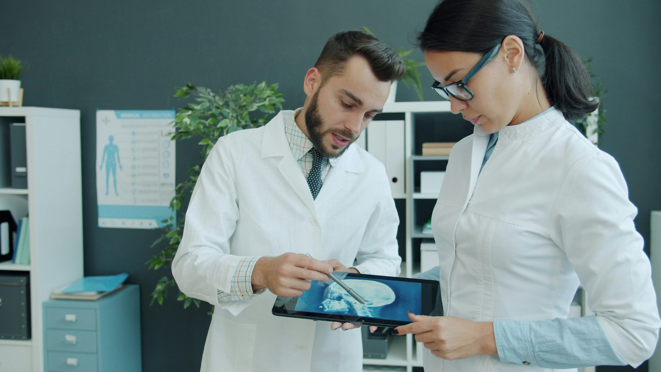 Two clinicians reviewing a scan on a tablet