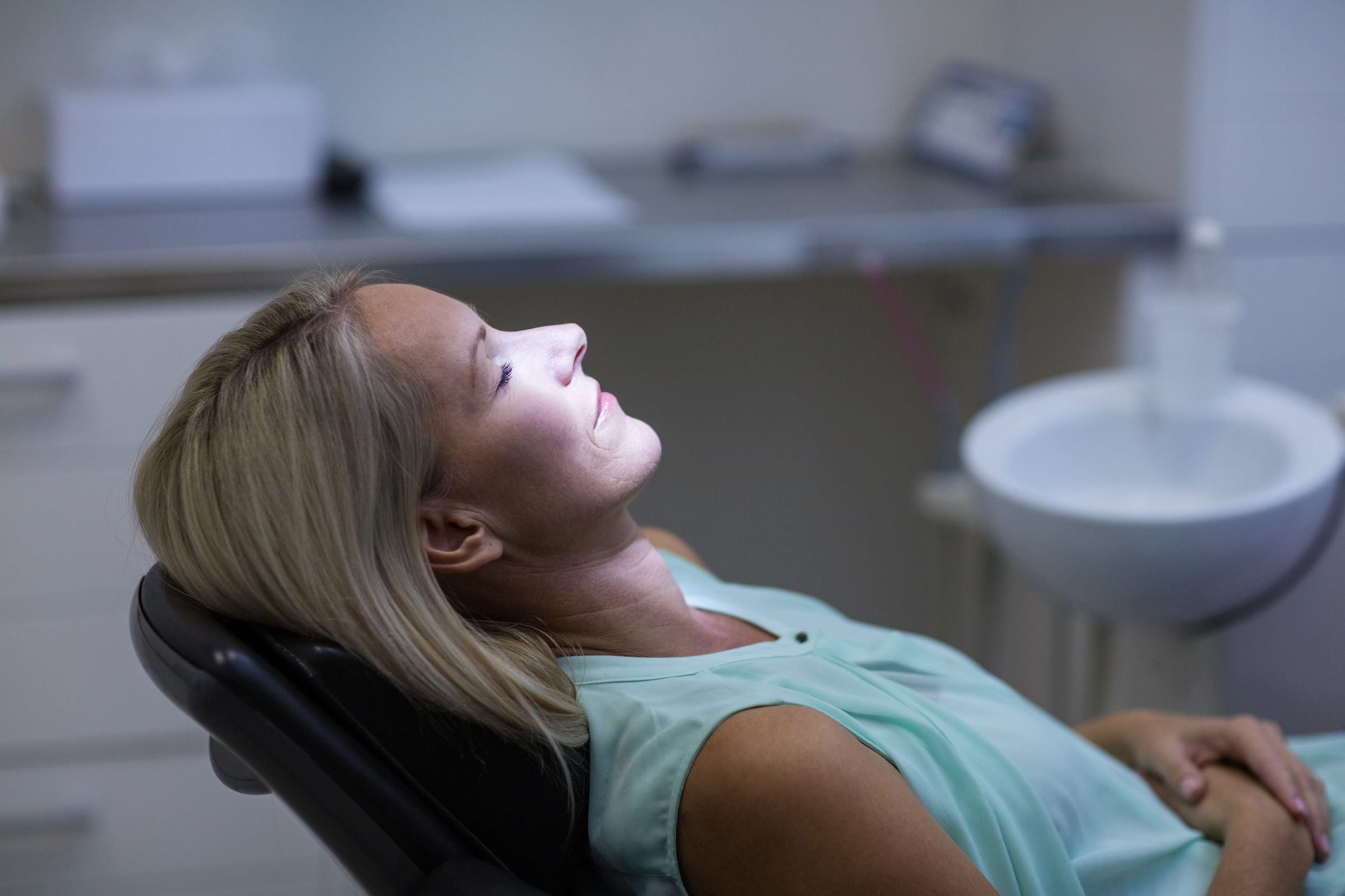 A relaxed patient under light sedation in the dental chair