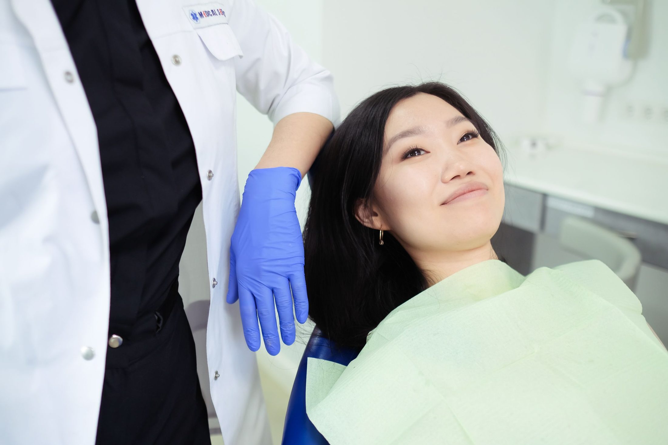A smiling woman in a dental chair at a check-up