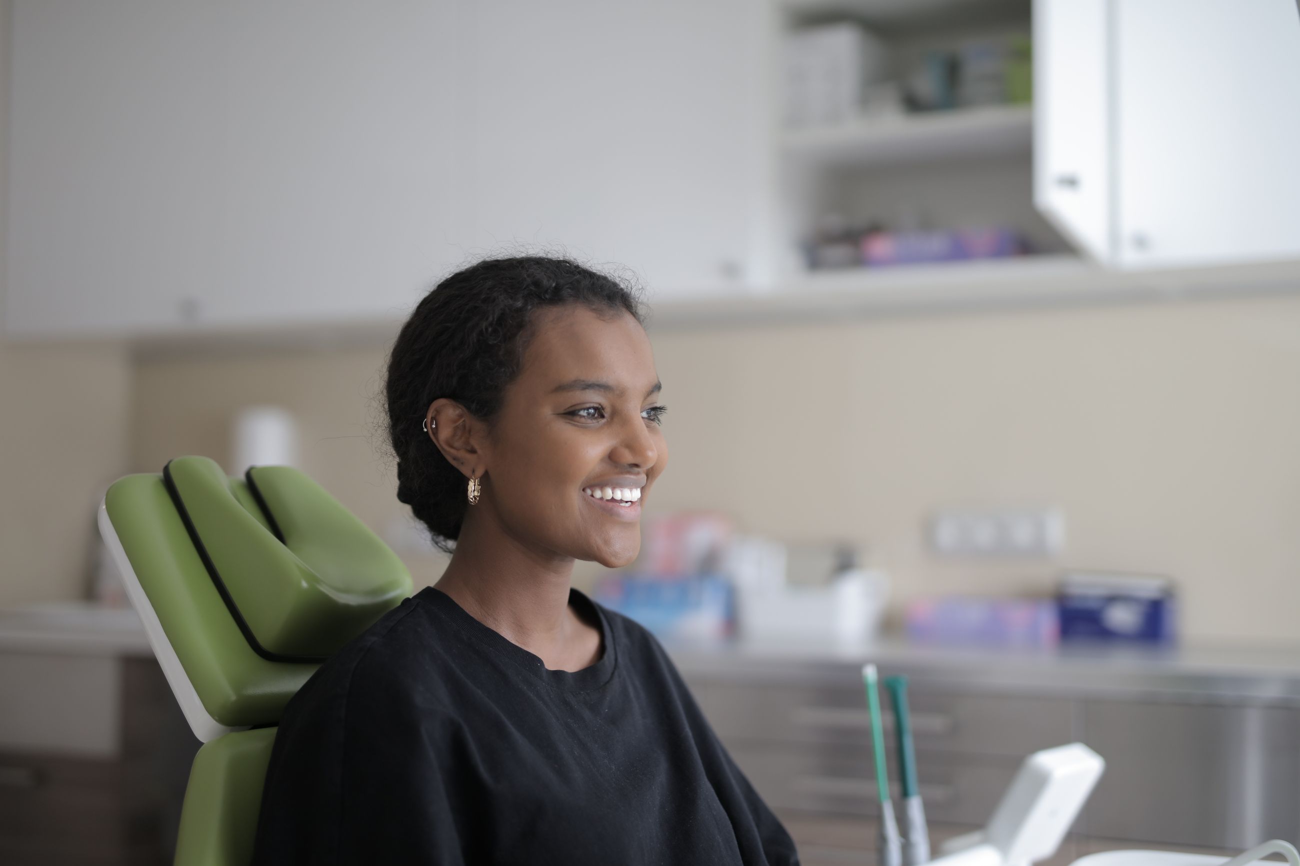 A smiling patient sitting in the dental chair