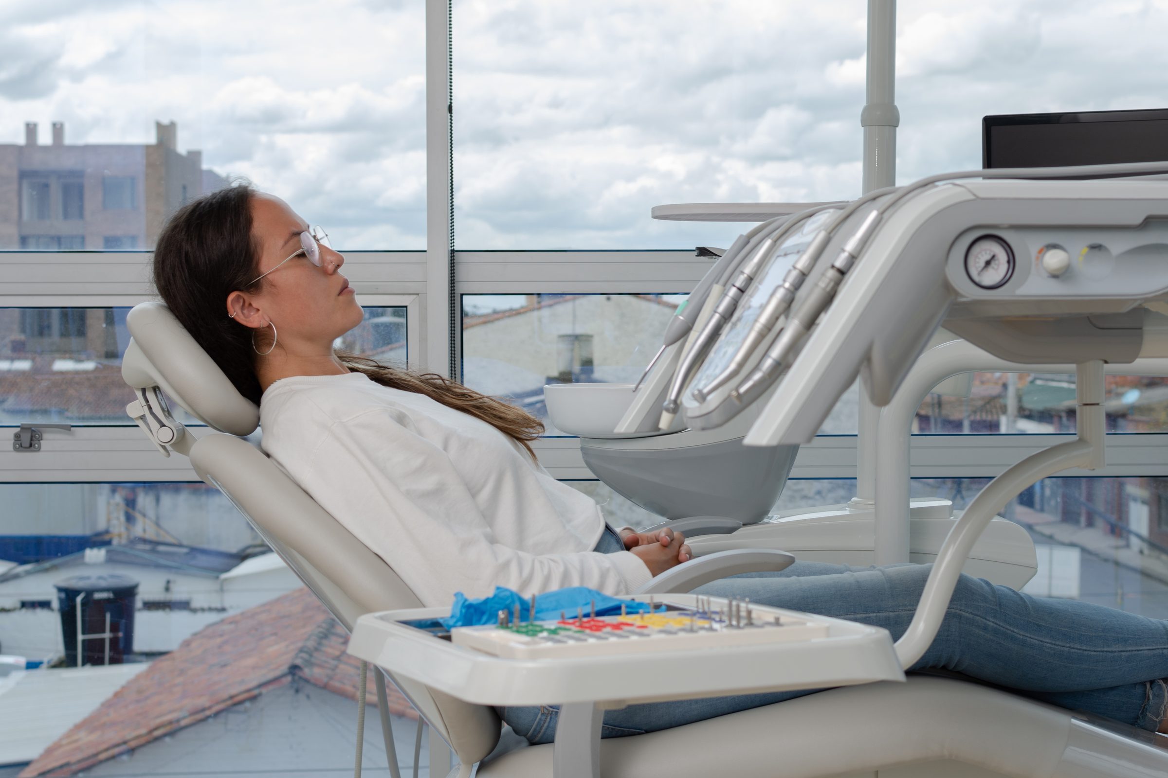 A patient resting in a reclined dental chair